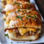Delicious Cowboy Breakfast Sliders topped with melted cheese and a buttery glaze, served in a baking dish, perfect for busy mornings or brunch gatherings